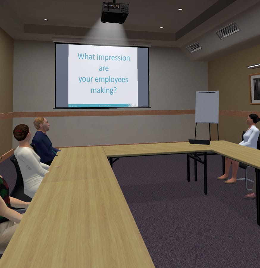 An audience in a meeting room viewing a slide that says "What Impression are your employees making?"
