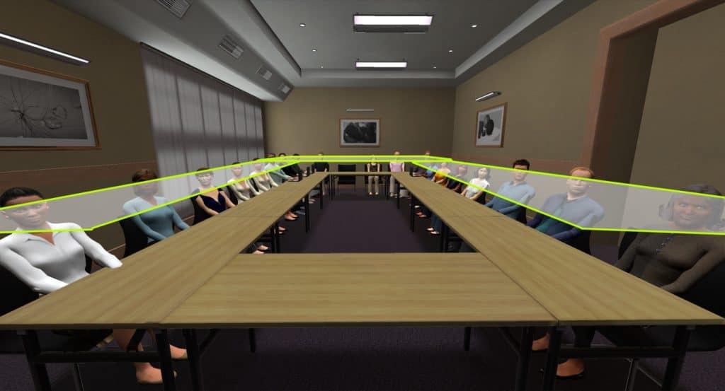 A larger meeting room with tables in a enlongated circle is shown. The speaker is on one end. Zones in long U form are shown.