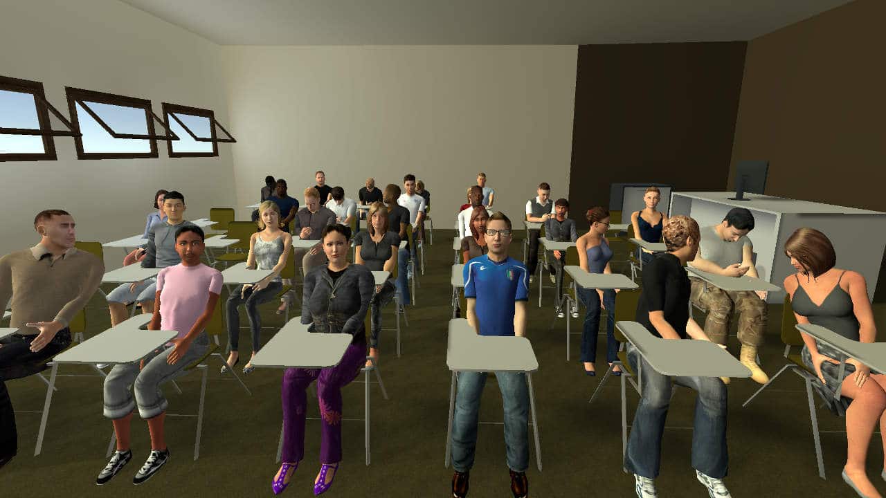 In a classroom setting, audience members in the front right have turned to a distraction from a mobile phone user.